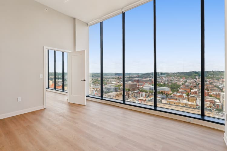 Cincinnati apartments for rent - image - A large empty room with a view of the city.
