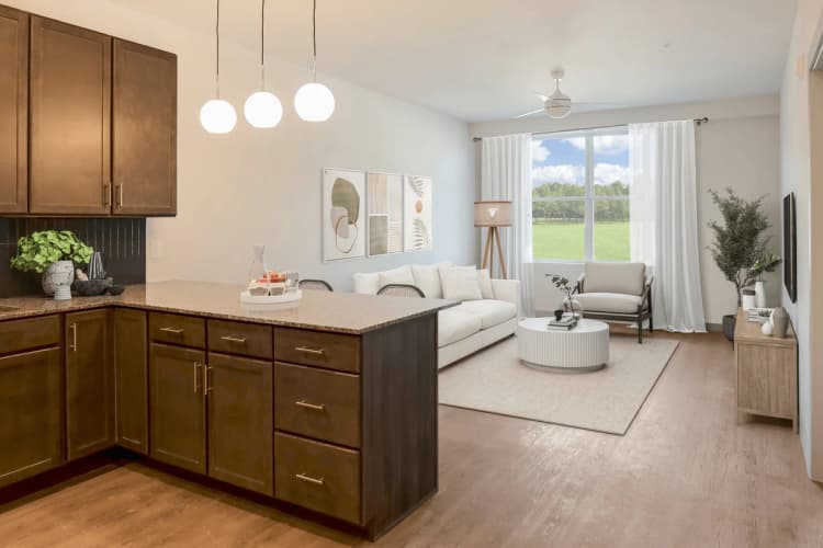 Cincinnati apartments for rent - image - Altura Apartments oversized kitchen featuring a breakfast bar with seating and granite countertops.