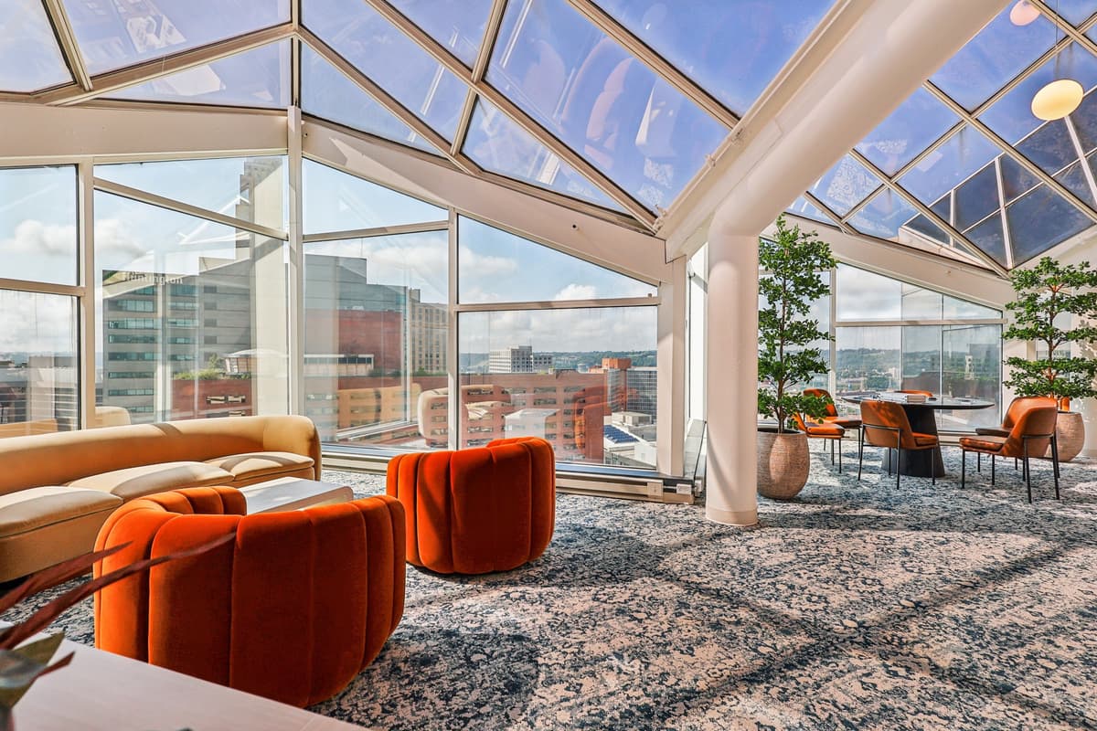 undefined apartments for rent - image - A room with orange chairs and a glass ceiling. - 3