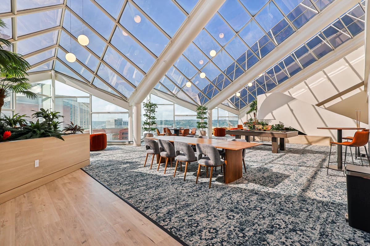 Cincinnati apartments for rent - image - A modern dining area with a glass ceiling and wooden furniture.