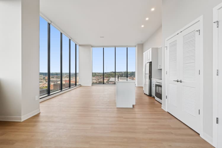 Cincinnati apartments for rent - image - A spacious kitchen and living room with a view of the city.