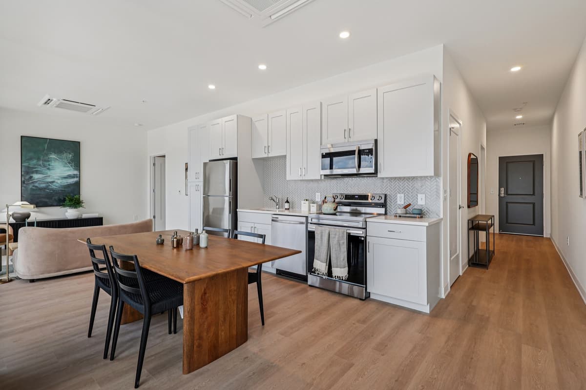 Cincinnati apartments for rent - image - A modern kitchen with a wooden table and chairs.