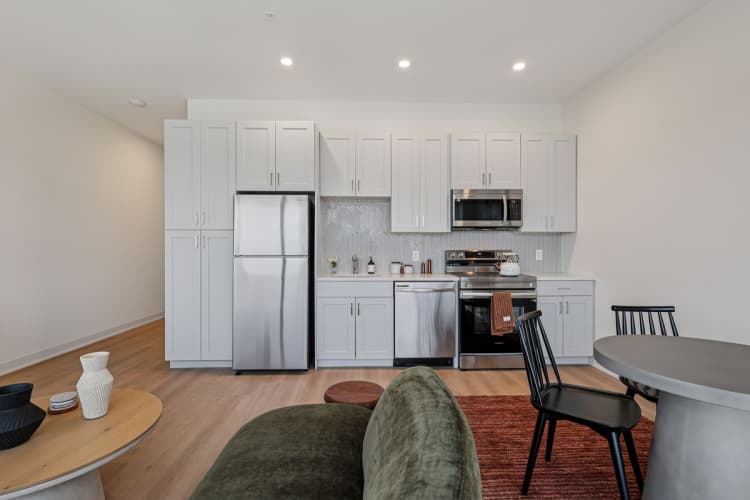 Cincinnati apartments for rent - image - A modern kitchen with a refrigerator, oven, and microwave.