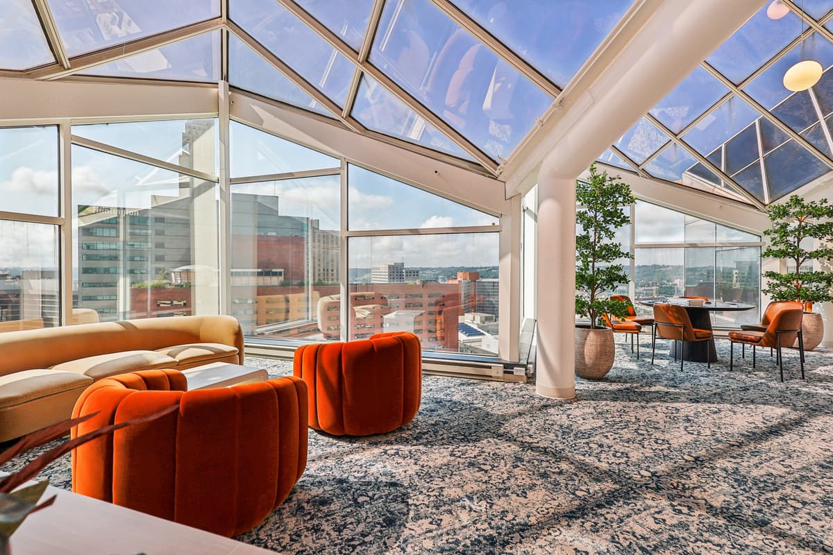 Cincinnati apartments for rent - image - A room with orange chairs and a glass ceiling.