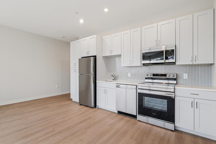 Cincinnati apartments for rent - image - A kitchen with white cabinets and stainless steel appliances.