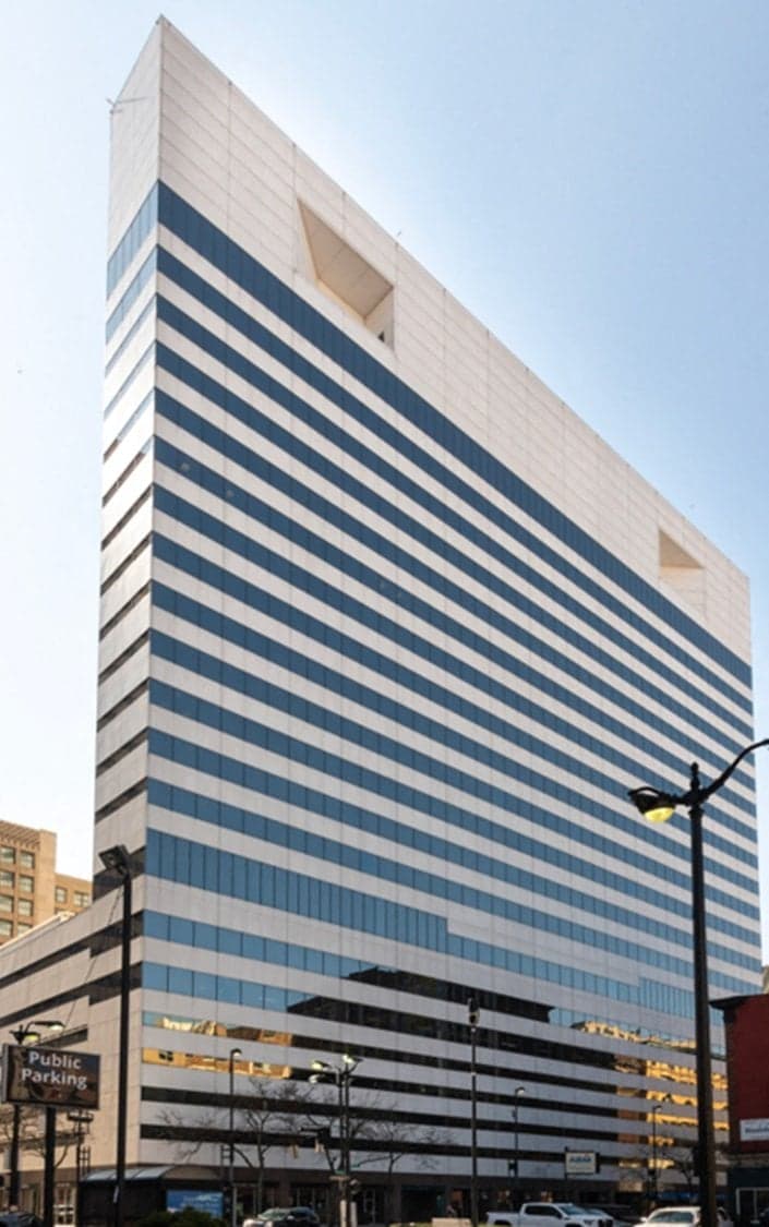 Cincinnati apartments for rent - image - A tall building with a blue and white striped facade.
