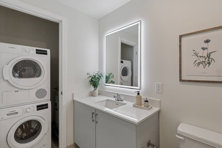 Cincinnati apartments for rent - image - A small bathroom with a washing machine in the doorway.