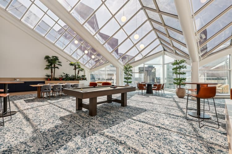 undefined apartments for rent - image - A room with a glass ceiling and a table surrounded by chairs.