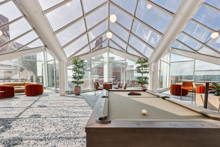 undefined apartments for rent - image - A billiard table is in the middle of a room with a glass ceiling.