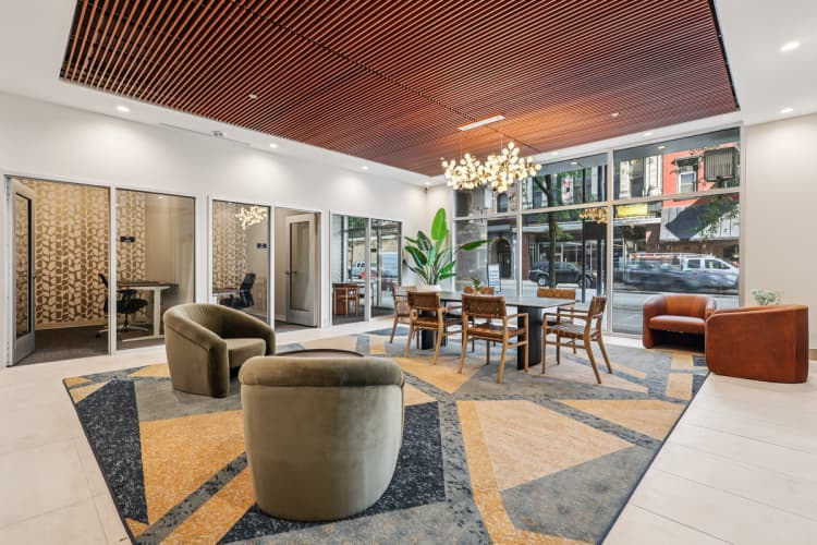 undefined apartments for rent - image - A modern living room with a wooden ceiling and a large rug.