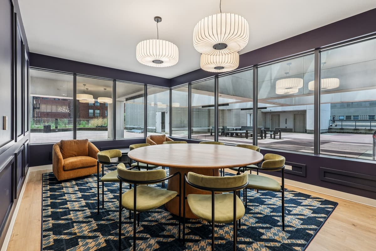 undefined apartments for rent - image - A modern dining room with a round table and chairs.