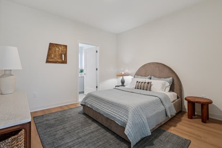 undefined apartments for rent - image - A bedroom with a large bed and a small table.